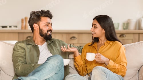A couple talking warmly on a sofa