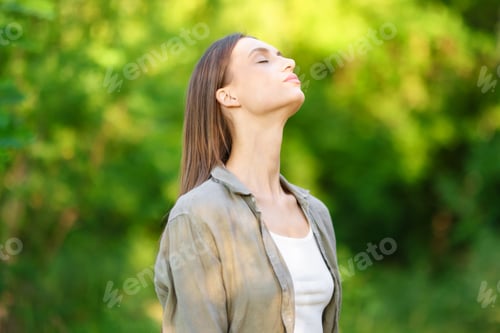 A woman breathing in fresh air outdoors